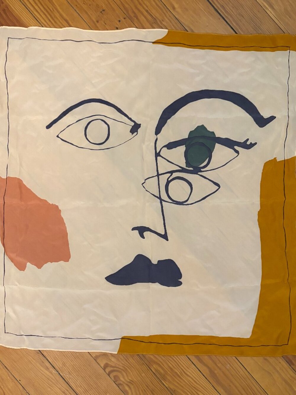 This abstract silk scarf features a surrealist design with organic shapes and li